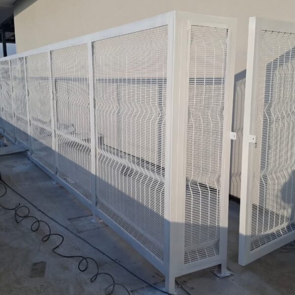 White clearview mesh plant screen with hinged access gate on a commercial building deck in Highlands, Harare